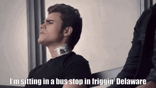 a man sitting in a bus stop in friggin delaware
