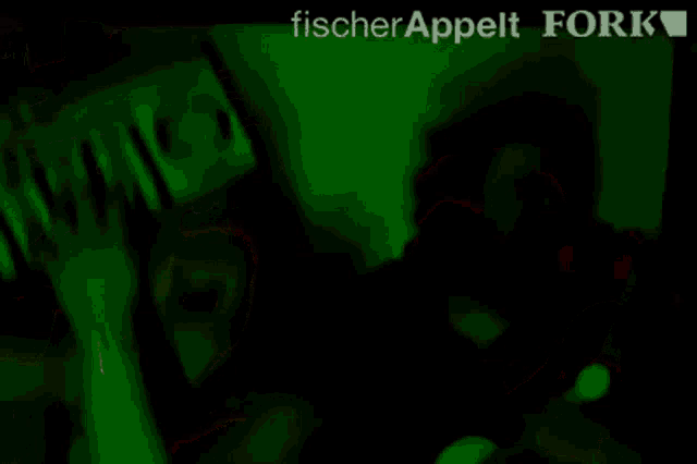 a blurry photo of a man and a woman with the words fischer appelt fork written above them