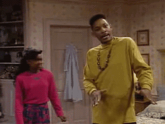 a man in a yellow shirt is dancing next to a woman in a pink sweater and the words mind ya business are visible