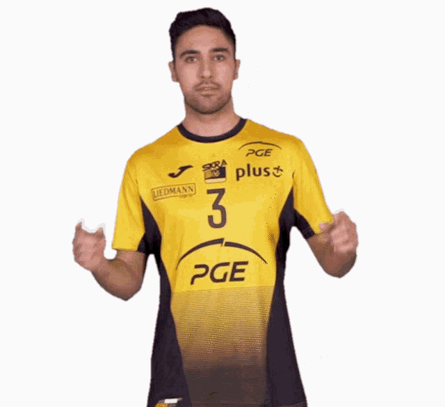 a man wearing a yellow and black shirt with pge on it