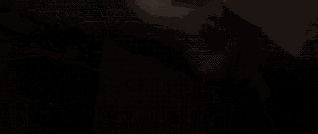 a woman in a yellow dress is standing in the dark