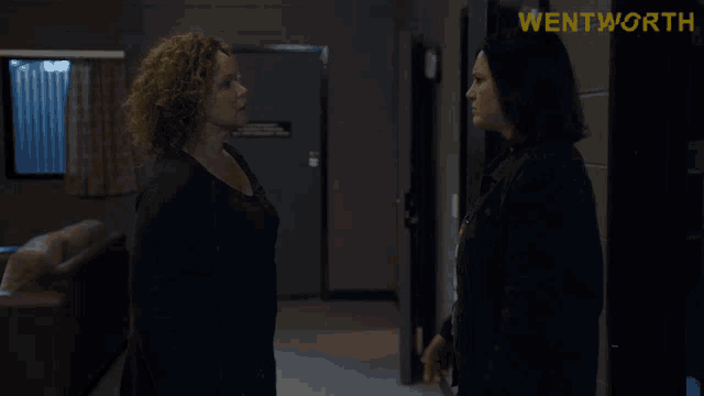 two women standing next to each other in a room with wentworth written on the bottom