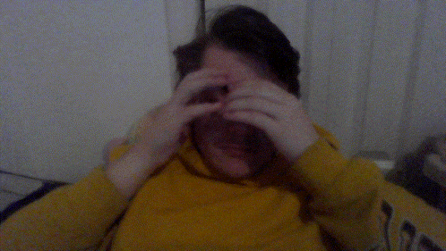 a man wearing a yellow sweatshirt with the word hawks on the sleeves