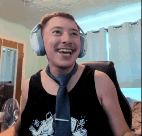 a man wearing headphones and a tie is smiling for the camera