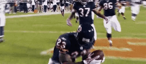 a football player with the number 37 on his jersey is kneeling on the field