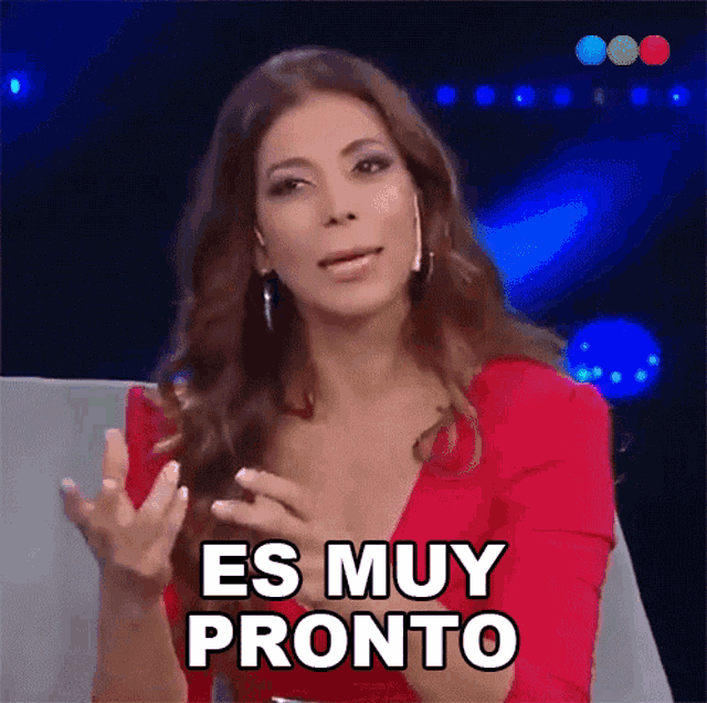 a woman in a red dress is saying " es muy pronto "