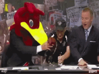 a mascot with a yellow beak is holding a football in front of espn