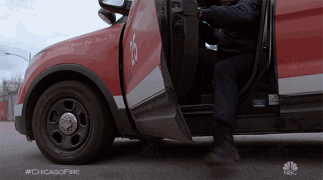 a man getting out of a chicago fire vehicle