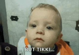 a baby is making a funny face with the words `` but tikki '' .
