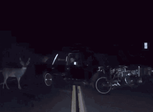 a man with a beard is sitting in a car with his head out the window .