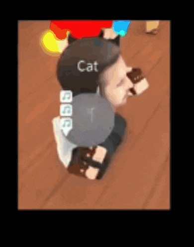 a person wearing a hat that says cat is kneeling on a wooden floor .