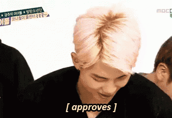 a man with pink hair says [ approves ] in front of a white background