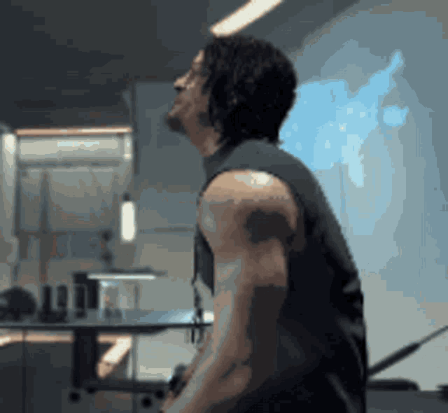 a man with a tattoo on his arm is looking up