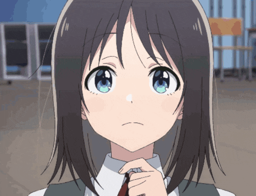 a close up of a girl 's face with her hands on her chin