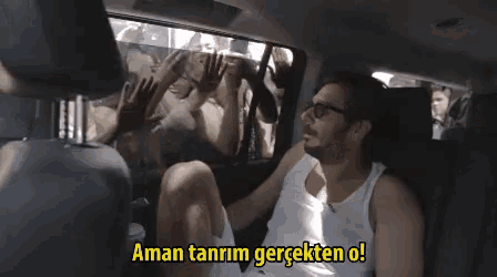 a man sits in the back seat of a car with the words aman tanrim gercekten o written above him
