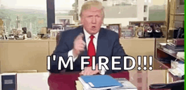 donald trump is sitting at a desk in an office giving a speech .
