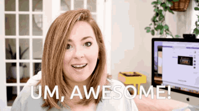 a woman says um awesome in front of a computer screen
