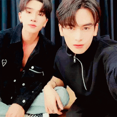 two young men are posing for a picture together .