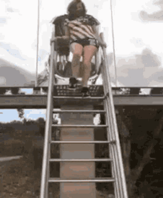 a woman is riding a roller coaster on a staircase .