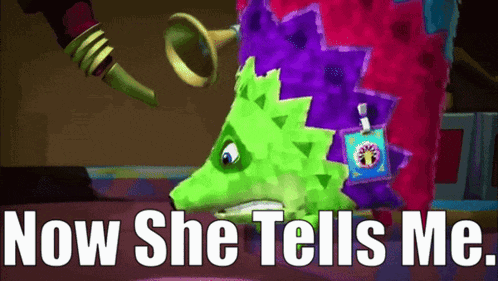 a green and purple monster with the words now she tells me