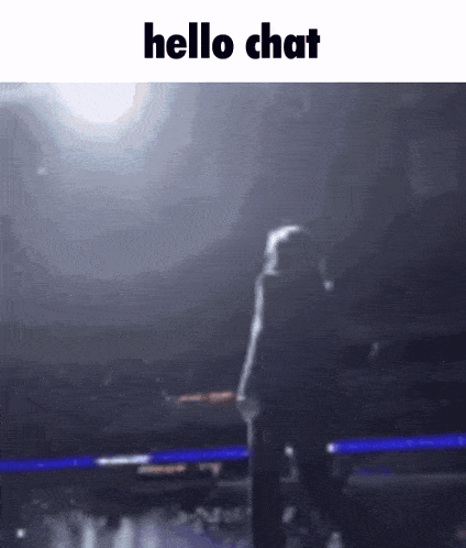 a blurred image of a person standing on a stage with the words `` hello chat '' written on it .