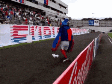 a person in a mascot costume walking on a track