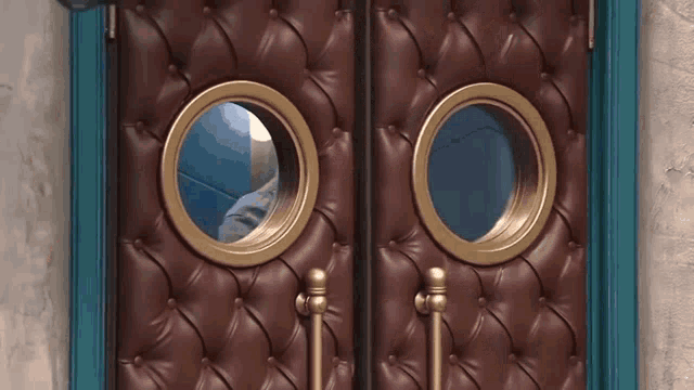 a close up of a door with two round windows on it
