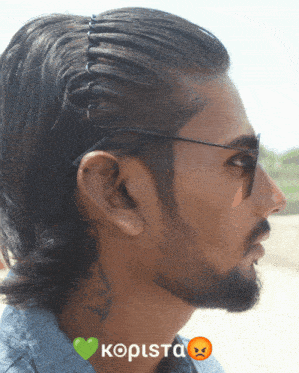 a man with a tattoo on his neck is wearing sunglasses and a headband that says kopista