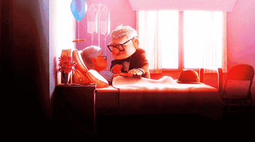 an elderly couple laying in a hospital bed
