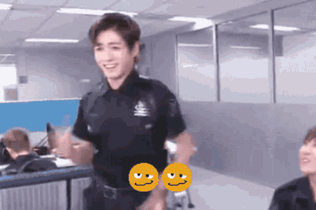 a man in a police uniform has two smiley faces on his shoulder