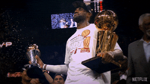 a man holding a trophy with the word netflix on the bottom right