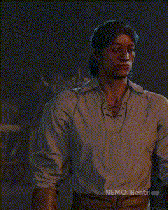 a man in a white shirt is standing in a dark room with nemo-beatrice written on the bottom