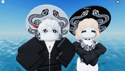 a boy and a girl are standing next to each other wearing hats with snakes on them and the name teffymv
