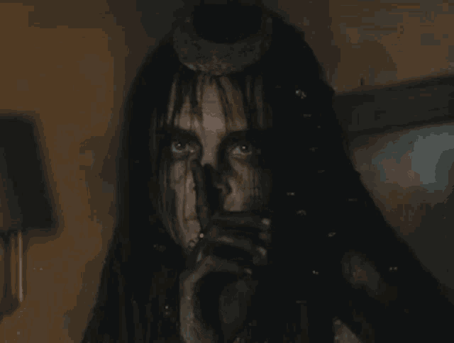 a close up of a person holding a gun in their hand and a gun in their mouth .