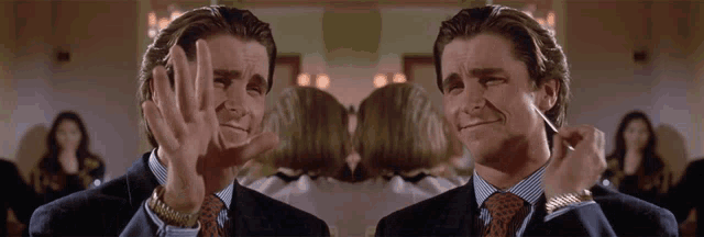 a man in a suit and tie is making a funny face