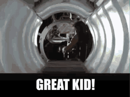 a person is standing in a tunnel with the words `` great kid '' written on the bottom .