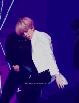 a man in a white jacket is dancing with the words dear my sunshine mighty written below him