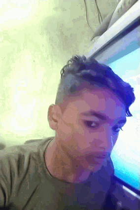 a person laying down with their head on a computer monitor