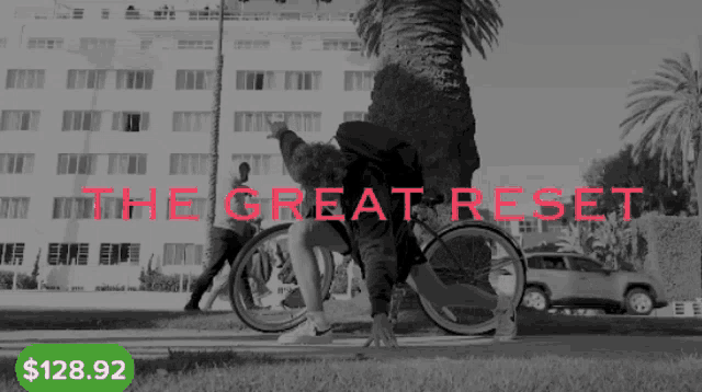 a black and white photo of a person riding a bike with the words " the great reset " in red