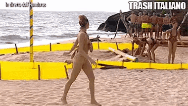 a woman in a bikini is walking on a beach with trash italiano written on the bottom