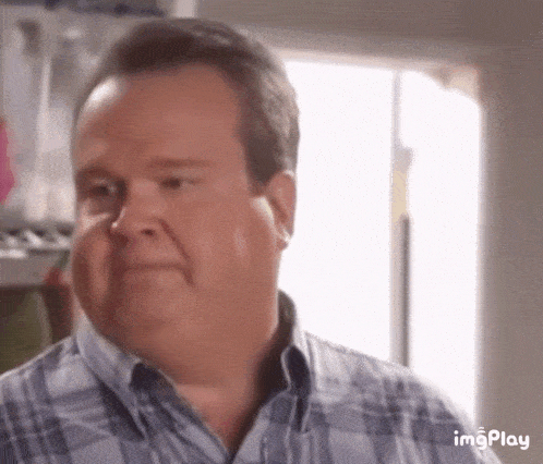 a man in a plaid shirt is making a funny face with imgplay in the corner
