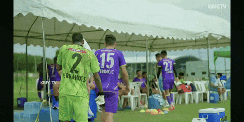 a soccer player wearing a green jersey with the number 2