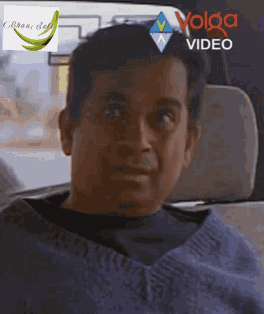 a man sitting in a car with a volga video logo on the side