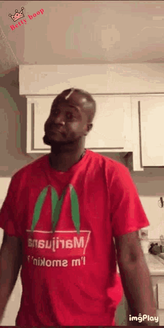 a man wearing a red mcdonald 's shirt is dancing