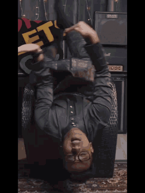 a man laying on his back holding a sign that says " let 's go "