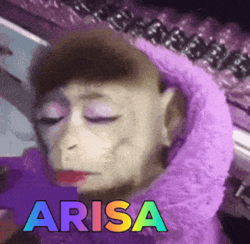 a monkey wearing makeup and a purple scarf with the word arisa above it