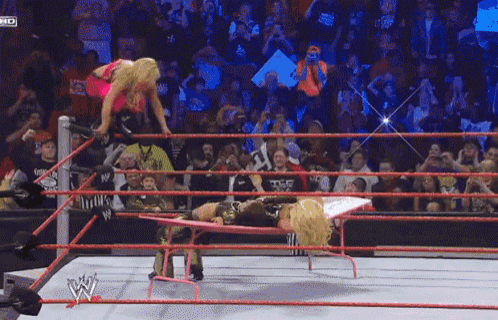 a woman in a wrestling ring with a sign that says ' tna ' on it