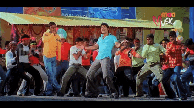 a group of people are dancing in front of a sign that says music