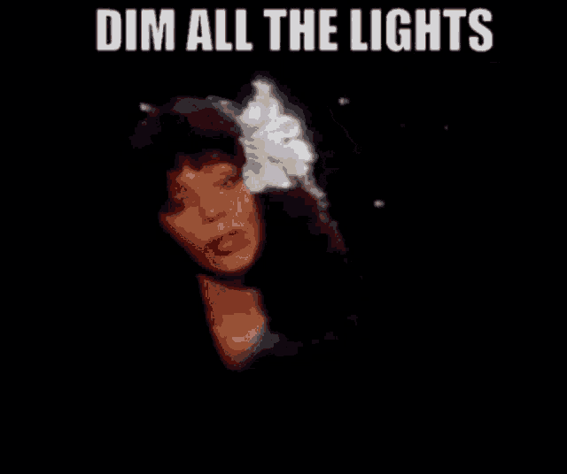 a picture of a woman with a flower in her hair and the words dim all the lights