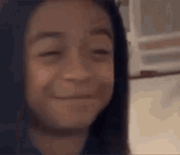 a close up of a person 's face with a blurred background .